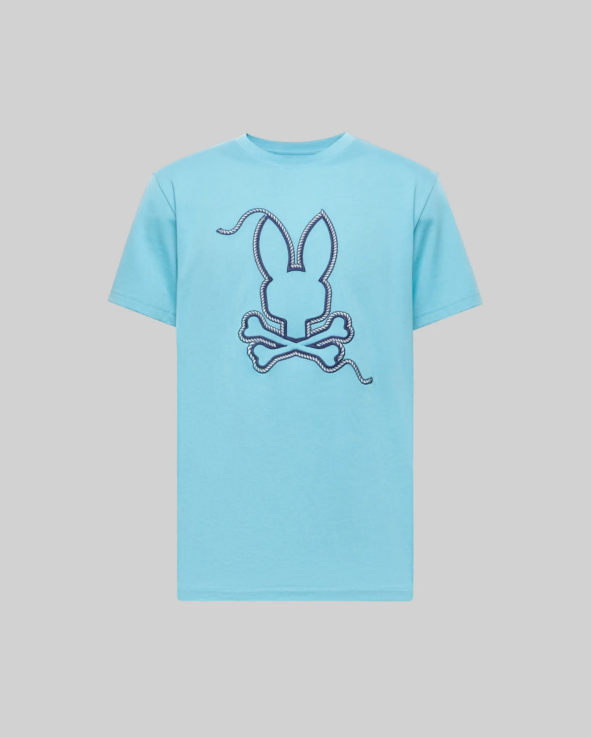 Psycho Bunny MENS CYRUS GRAPHIC TEE (MT0200115) in light blue, made from soft Pima cotton, features a bold stitched bunny head and crossed bones graphic on the front with dashed line accents, set off by a plain gray background.