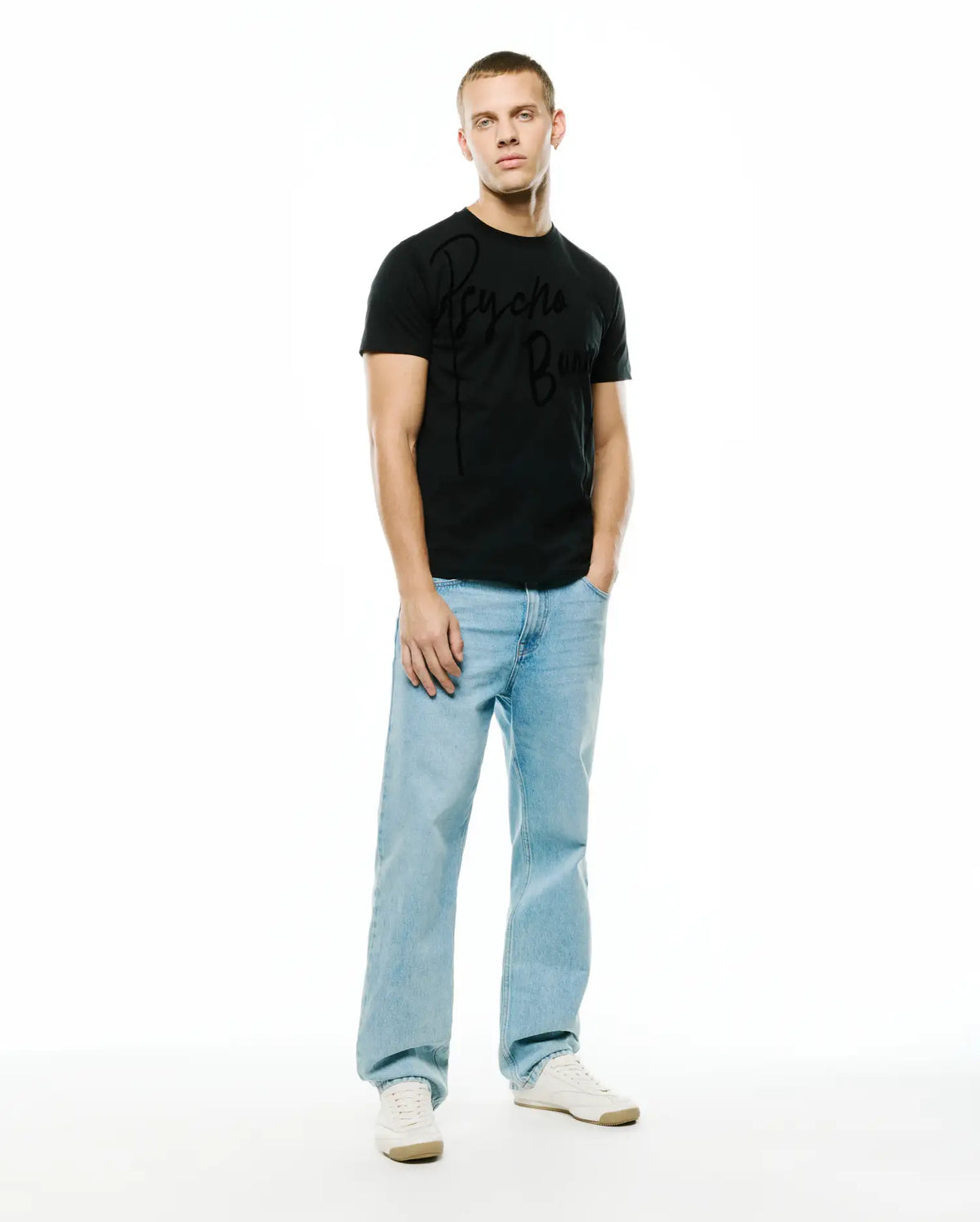 Mens Soren Graphic Tee, a black classic fit jersey t-shirt featuring a prominent, large tonal black Psycho Bunny script logo graphic across the chest, embodying refined streetwear style. (5)
