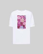 The MENS ROWEN OVERSIZED TEE - MT0200194 by Psycho Bunny is a relaxed fit white Pima cotton t-shirt with pink, white, and blue floral graphics on the chest and “Psycho Bunny” printed below, displayed on a plain grey background.