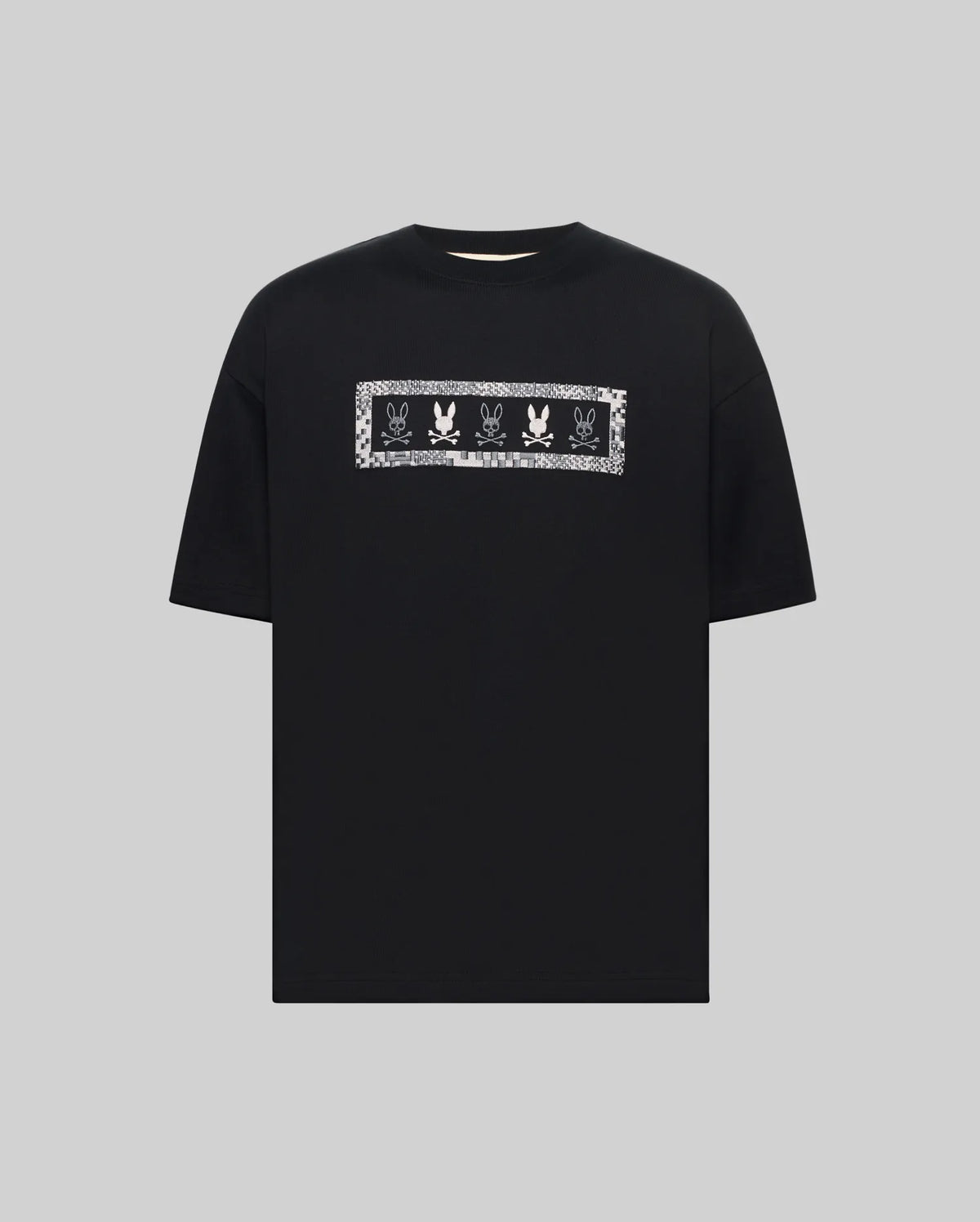 MENS OLIVIER OVERSIZED TEE, a black jersey t-shirt featuring a large white embroidered Psycho Bunny skull logo graphic on the chest, framed by a subtle checkered pattern.