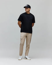 Mens Oscar Oversized Tee, a black smooth jersey t-shirt featuring a relaxed fit and a small, tonal embroidered Psycho Bunny skull logo on the left chest.