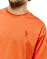 Men's Oscar Oversized Tee in heathered orange jersey knit, featuring a small, tonal embroidered Psycho Bunny skull and crossbones logo on the left chest. (3)