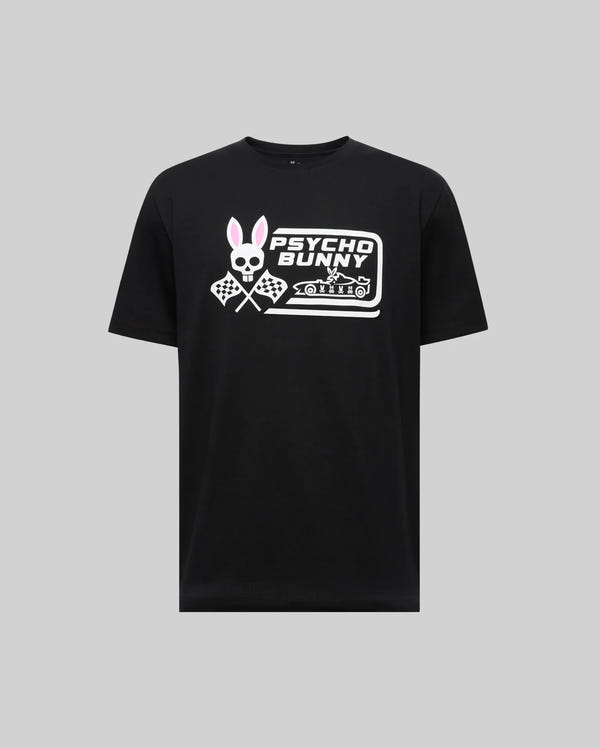 The Psycho Bunny MENS RACING GRAPHIC TEE (MT0200243) is a black Pima cotton t-shirt featuring a bold white skull bunny logo with pink ears, crossed checkered flags, and "Psycho Bunny" text across the chest.