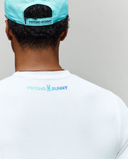 A person wearing a light blue Psycho Bunny cap and the MENS OFFICIAL US OPEN AVERY NET PERFORMANCE TEE (MT0200273), both with matching back logos, viewed from behind against a plain background.