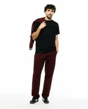 Mens Royce Graphic Tee, a black classic fit jersey t-shirt with a tonal Psycho Bunny chest graphic, paired with relaxed fit maroon french terry sweatpants and a matching sweatshirt with striped cuffs. (5)