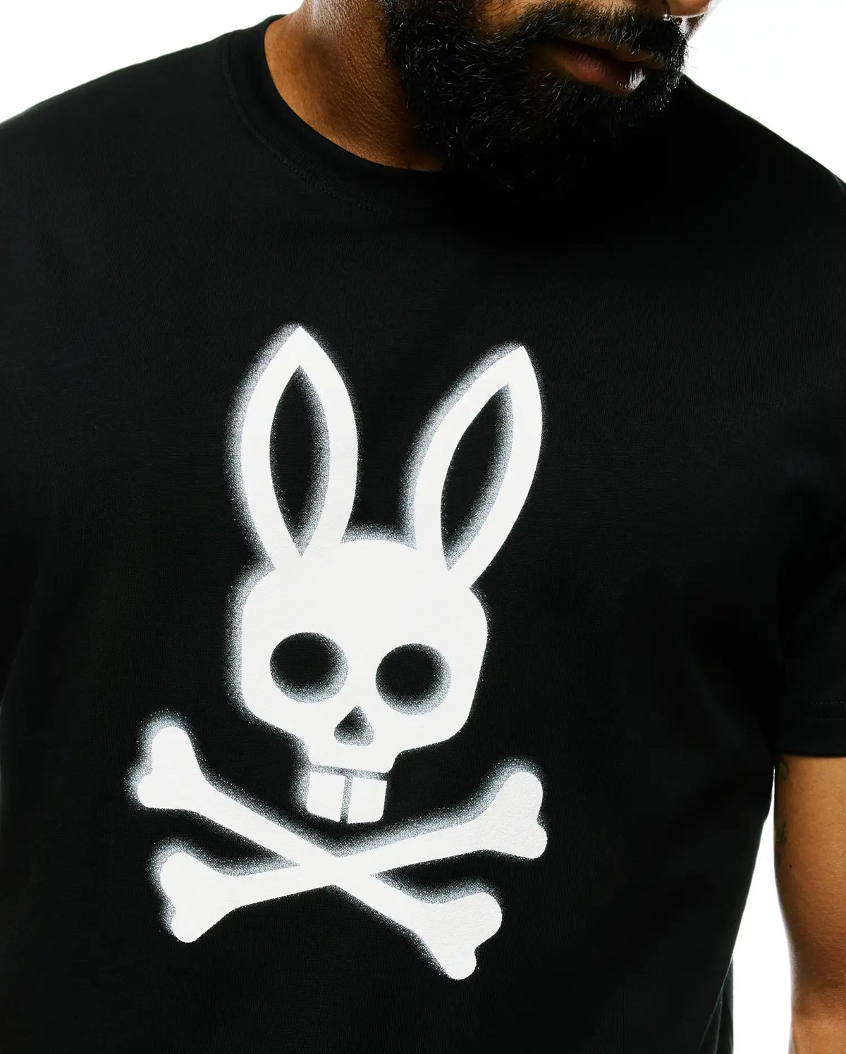 Mens Emmanuel Pima Cotton Graphic Tee, a classic fit black Pima cotton jersey t-shirt featuring a large, spray-painted white Psycho Bunny skull and crossbones graphic on the center chest. (3)