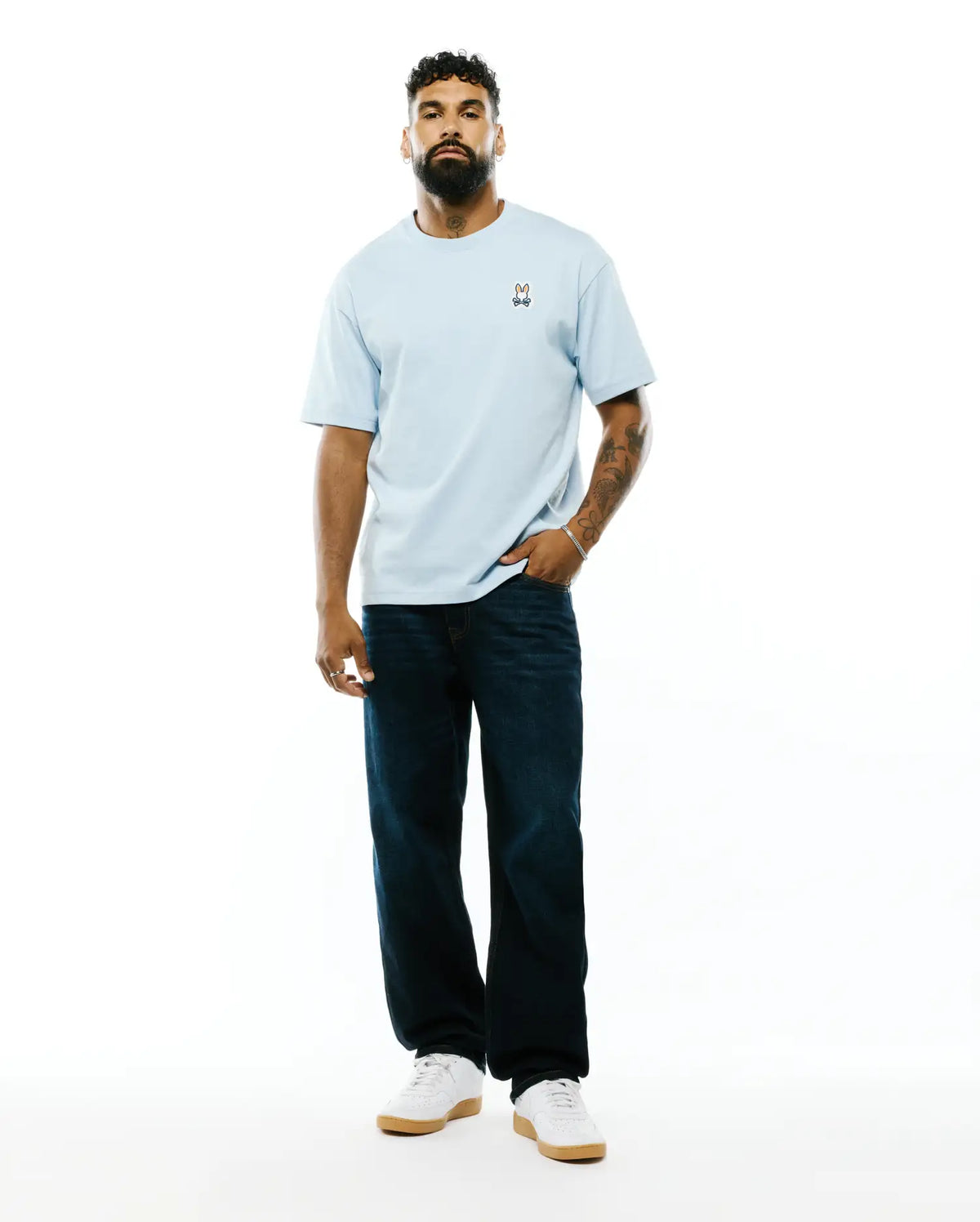 Mens Jaydon Pima Cotton Oversized-Fit Tee in light blue, featuring a soft jersey texture and a small, colorful embroidered Psycho Bunny skull logo on the left chest. (4)