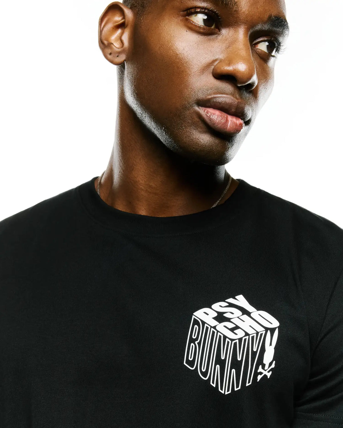 Men's Conan Pima Back Graphic Tee, black classic fit Pima cotton jersey t-shirt with a white 3D-effect Psycho Bunny text logo and small bunny skull on the left chest. (3)