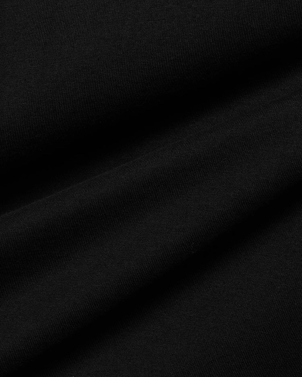 Men's Conan Pima Back Graphic Tee, a premium black Pima cotton jersey fabric, showcasing its fine, soft texture and subtle diagonal ribbing from the knit, with gentle folds. (6)