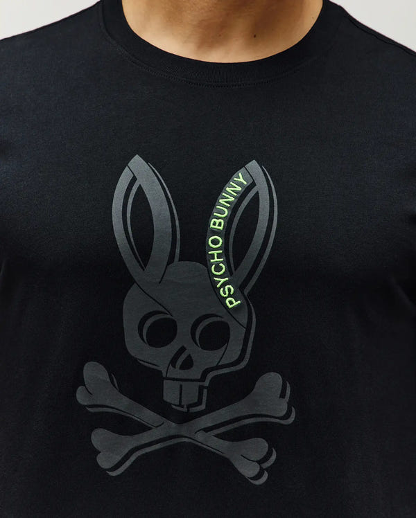 Mens Serge Embroidered Bunny Graphic Tee, black classic fit jersey knit with a large dark grey bunny skull and crossbones print, accented by neon green embroidered Psycho Bunny text.