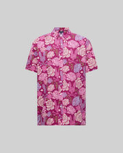 The Psycho Bunny MENS ROWEN SHIRT (MT0300038) is a short-sleeved, button-up cotton blend shirt with a pink, purple, and white floral pattern on a magenta background, shown on a plain gray backdrop.