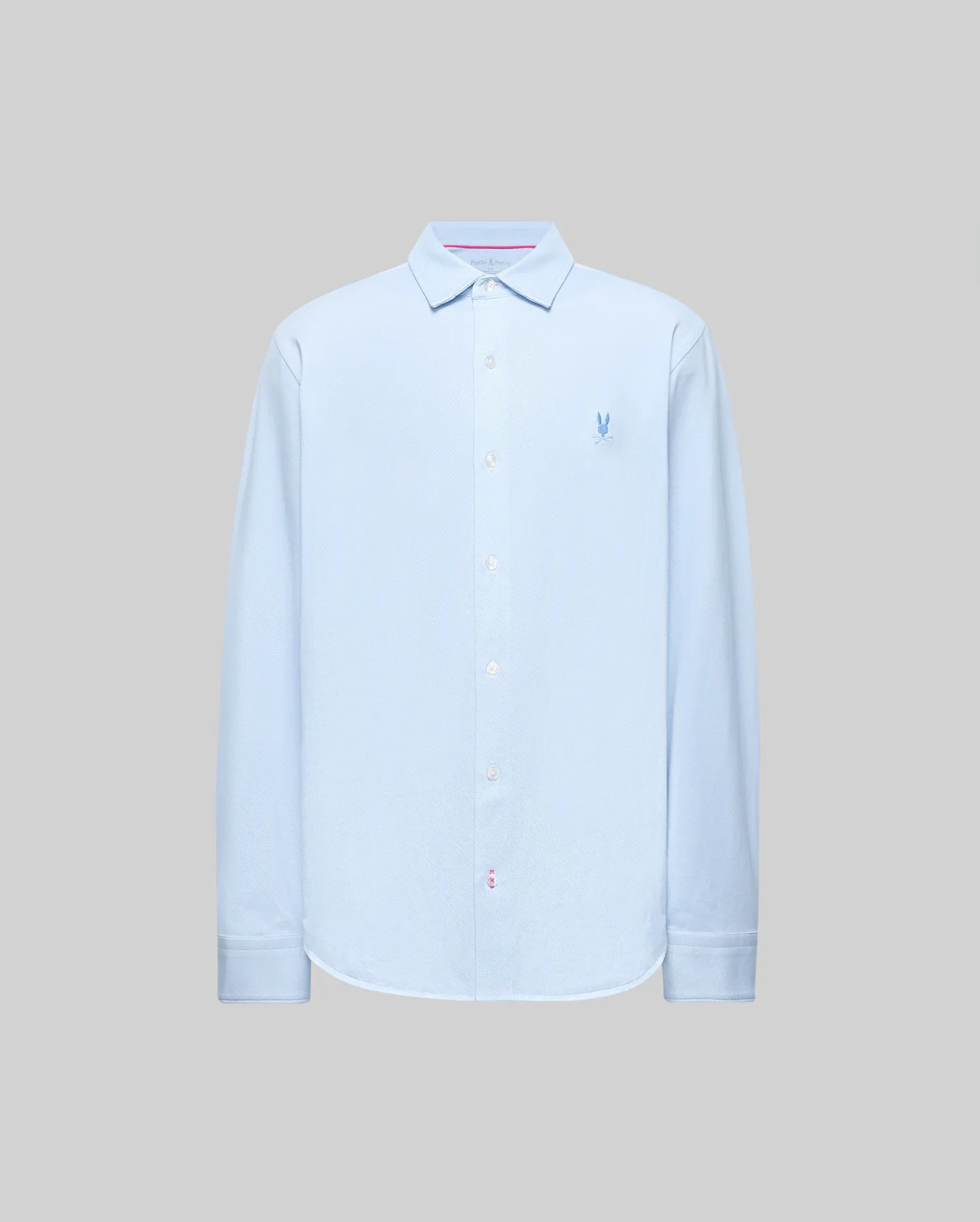 The Psycho Bunny MENS JIM JERSEY STRIPED KNIT SHIRT (MT0300041) is a light blue, long-sleeve pima cotton shirt with a collar and small embroidered blue logo on the left chest, shown against a plain gray background.
