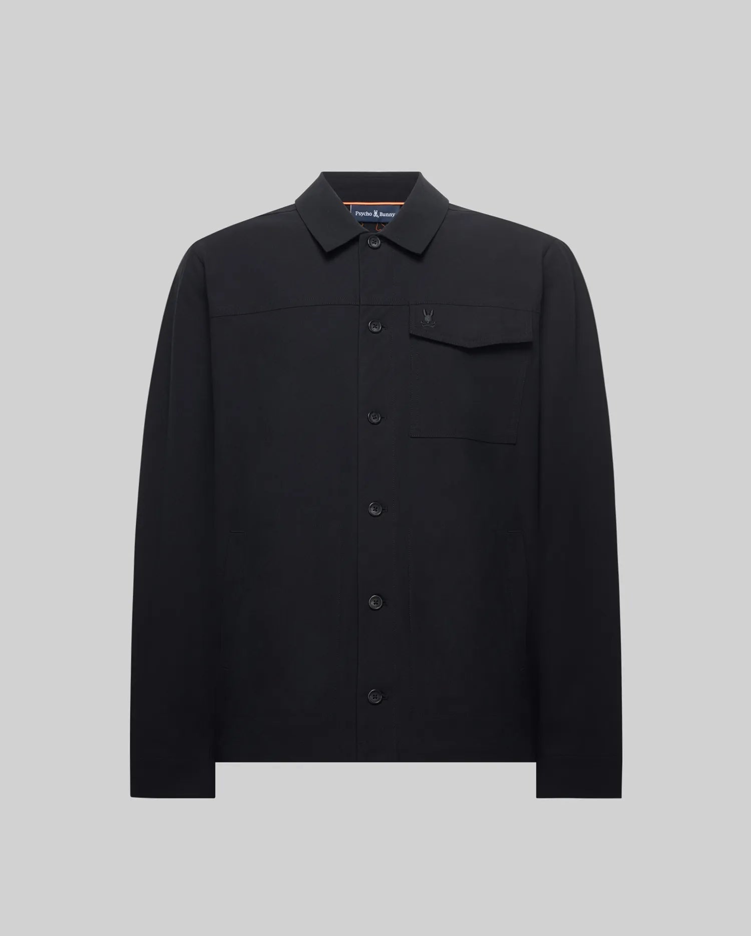 Black Mens Maverick Overshirt with a classic fit, smooth woven fabric, collared, full button-front, long sleeves, and a single chest pocket featuring a small, tonal embroidered Psycho Bunny skull logo.