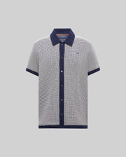 Mens Maxton Waffle Shirt, a classic short-sleeve polo in navy/white micro-pattern waffle knit, solid navy collar, placket, cuffs, hem, and embroidered Psycho Bunny skull logo on left chest.