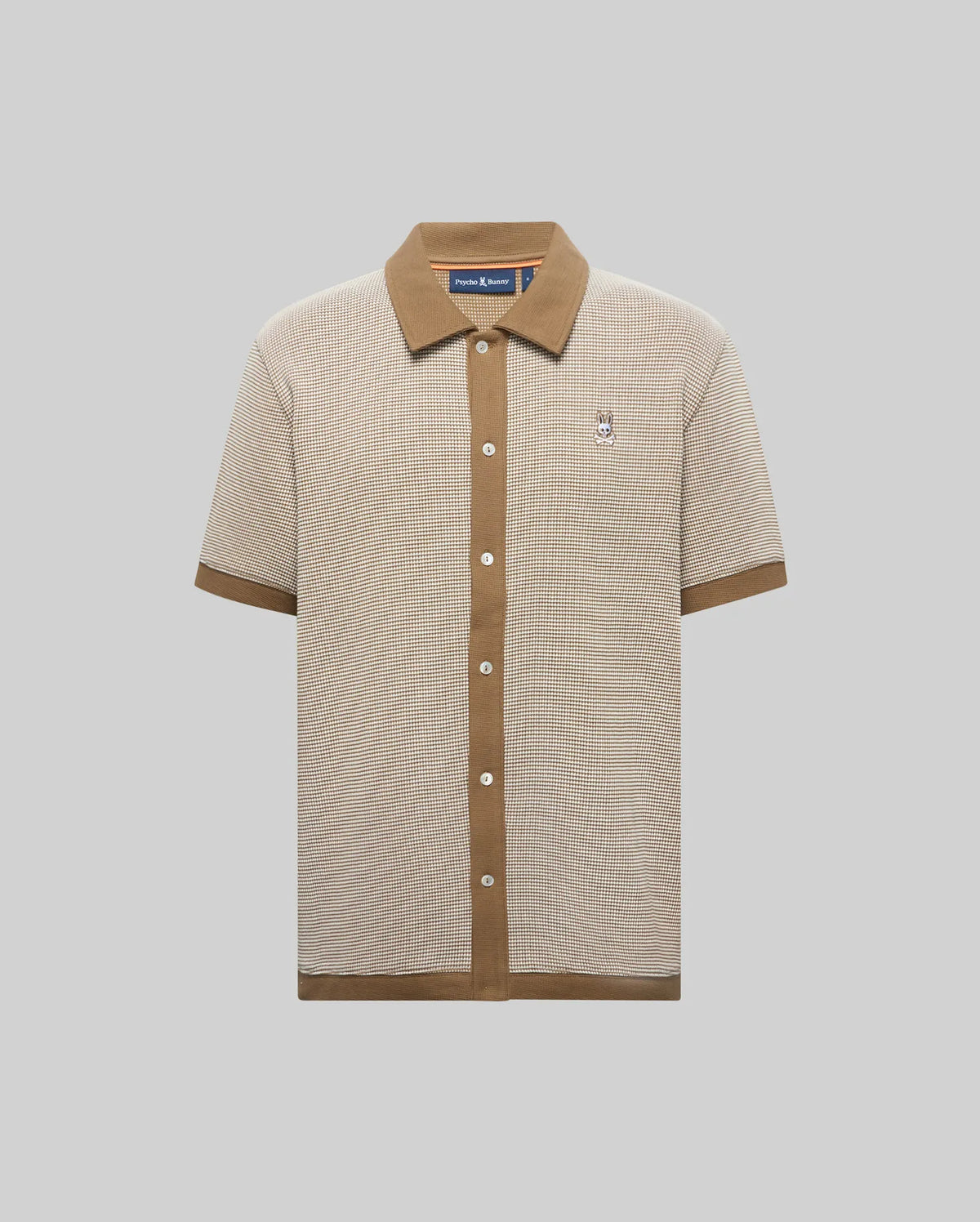 Mens Maxton Waffle Shirt in beige waffle knit with contrasting brown ribbed collar, full button placket, cuffs, and hem, featuring a small embroidered Psycho Bunny skull logo on the left chest.