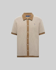 Mens Maxton Waffle Shirt in beige waffle knit with contrasting brown ribbed collar, full button placket, cuffs, and hem, featuring a small embroidered Psycho Bunny skull logo on the left chest.