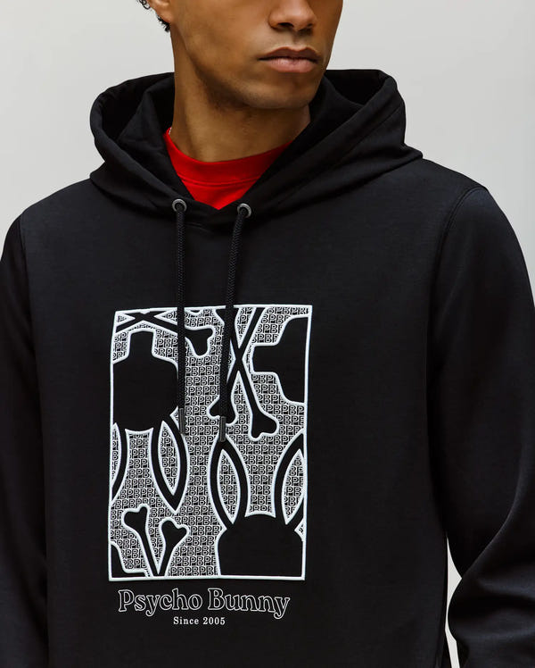 A person wears the Psycho Bunny MENS GLENN HOODIE (MT0500008), crafted from a soft cotton-modal blend, with an embroidered Bunny graphic of abstract shapes, bones, and “Psycho Bunny Since 2005” text below the design.