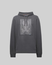 The Psycho Bunny MENS GRANT HOODIE - MT0500032 is a dark gray cotton-blend hoodie featuring a kangaroo pocket and a white horizontal-line bunny skull and crossbones graphic on the chest.
