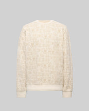 The Psycho Bunny MENS REED FLOCK CREW - MT0500041 is a cream crewneck pullover made from a premium cotton blend, showcasing an all-over beige cartoon bunny pattern and "BBX" text on a gray background.