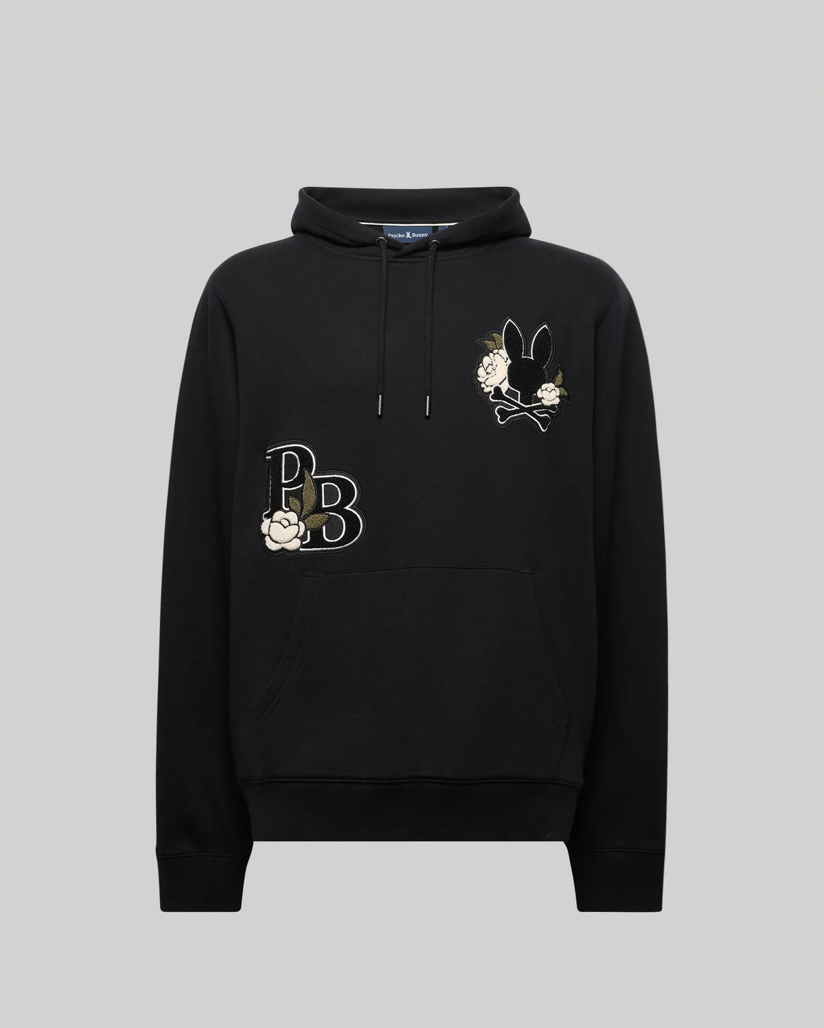 The MENS AUGUSTE HOODIE - MT0500043 by Psycho Bunny is a premium cotton regular fit hoodie with a front pocket, white flower embroidery, "PB" on the left chest, and a black bunny holding flowers on the right chest. Displayed on gray.