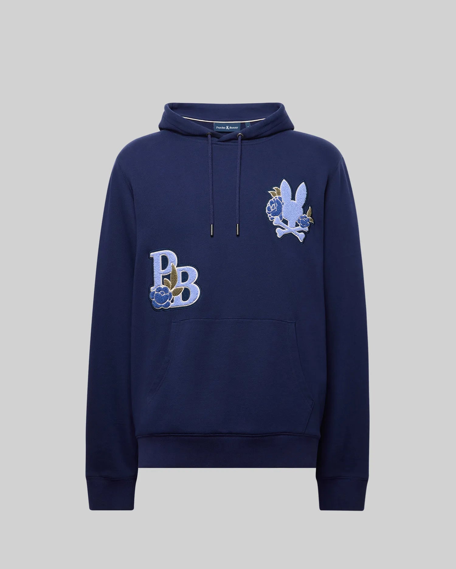 The Psycho Bunny MENS AUGUSTE HOODIE (MT0500043) is a navy blue premium cotton regular-fit hoodie with a front pocket, featuring "PB" embroidered with a blue rose and a chenille-detailed white rabbit head on the chest.