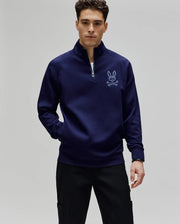 Mens Tate 1/4 Zip Chenille Pullover in deep navy, featuring a classic fit, smooth knit fabric, stand-up collar, and a prominent light blue chenille Psycho Bunny skull logo embroidered on the left chest.