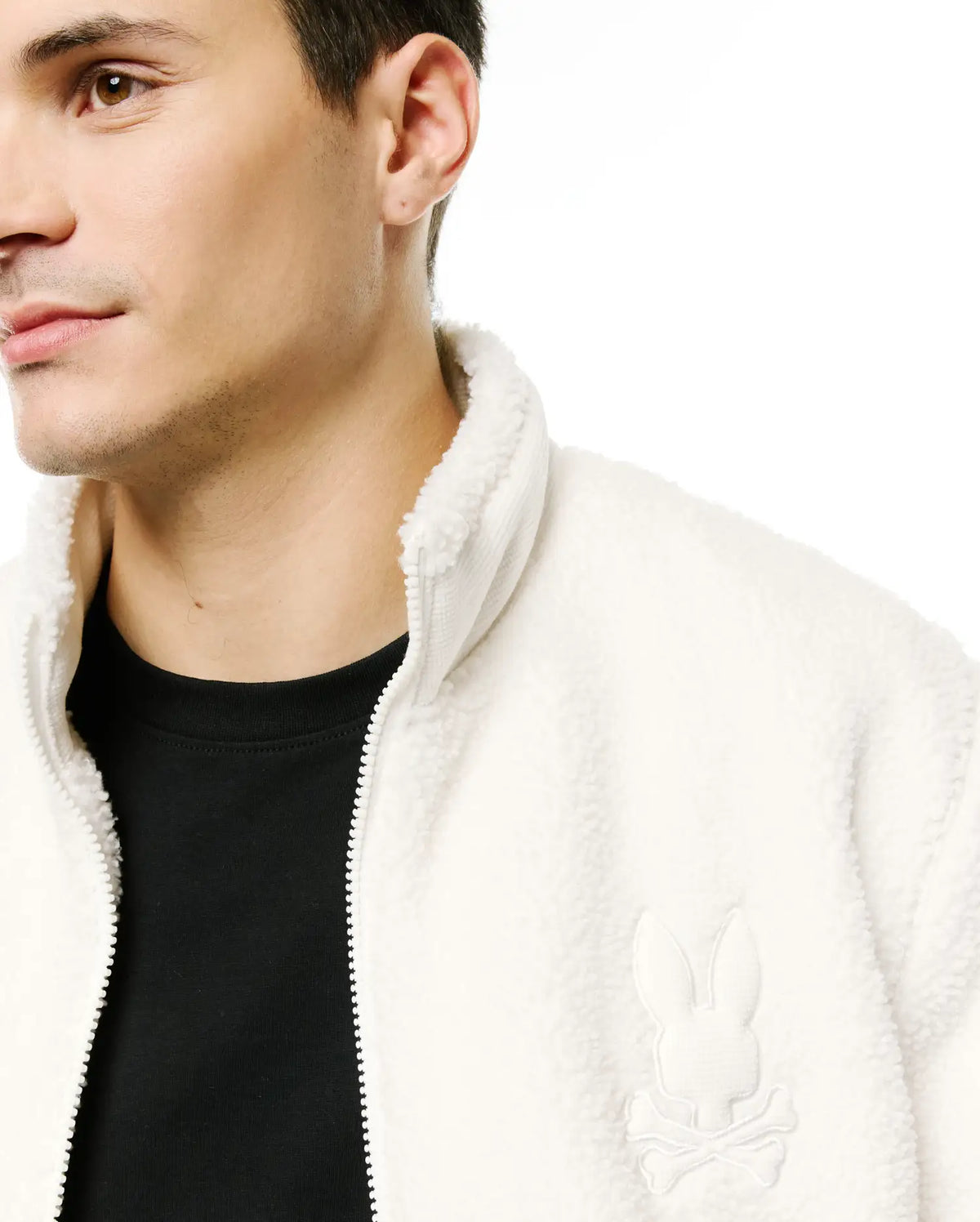 Men's Rowley Sherpa Zip Jacket in cream, featuring a cozy sherpa fleece texture, full zip closure, stand collar, and a small embroidered Psycho Bunny skull logo on the left chest. (3)