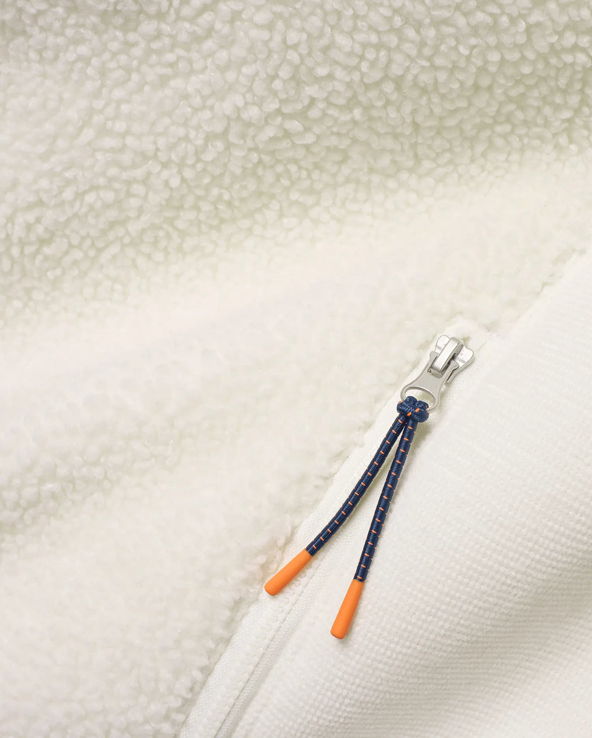 Men's Rowley Sherpa Zip Jacket featuring creamy sherpa fleece and textured knit fabric, a silver zipper, and a navy cord zipper pull with bright orange tips. (7)