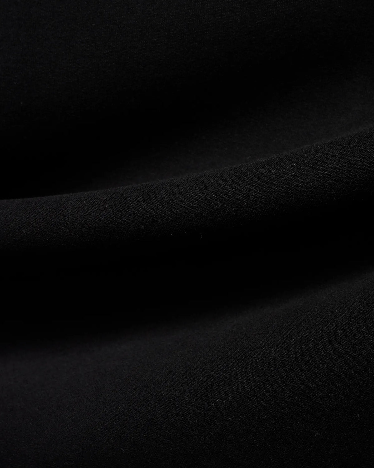 Men's Samson Quarter-Zip Sweater in classic black, crafted from a soft, smooth jersey knit fabric, showcasing its premium texture with subtle folds. (6)