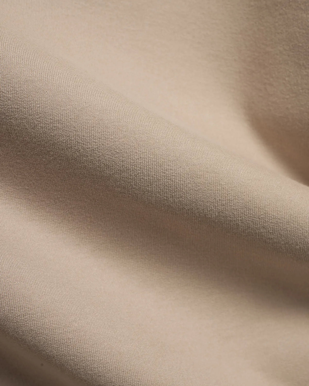 MEN'S SAMSON QUARTER-ZIP SWEATER in a premium, soft beige knit fabric, featuring a subtle vertical texture and gentle folds, indicating a comfortable, refined style. (6)