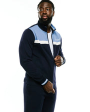 Men's Jacques Pique Track Jacket in navy with light blue and white color block panels, full zip, ribbed cuffs, and an embroidered Psycho Bunny script logo on the left chest. (3)