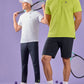 Two men posing in sporty attire with tennis rackets, one in a white Psycho Bunny Mens Classic Polo and pants, the other in a green Psycho Bunny Mens Classic Polo and black shorts against a purple background.