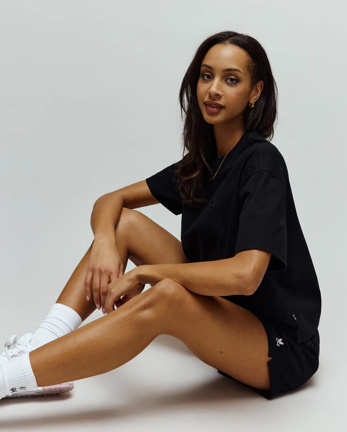 Black relaxed jersey t-shirt with a tonal embroidered bunny skull logo on the chest, paired with Womens Olivia Fleece Short in black fleece, featuring a white and pink embroidered bunny skull logo on the left thigh.