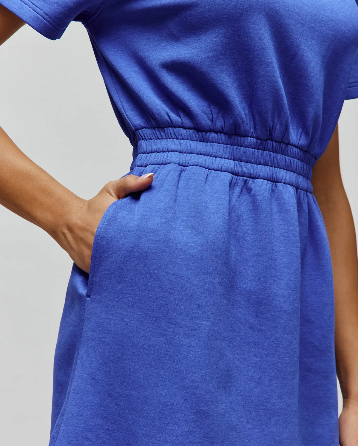 Womens Penelope Dress in vibrant royal blue soft jersey knit, featuring short sleeves, a relaxed fit, elasticated waist, and practical side pockets.