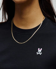 Black Womens Penelope Dress in soft jersey knit, showcasing the iconic small embroidered white and pink Psycho Bunny skull logo on the left chest, embodying refined streetwear.