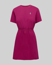 Womens Penelope Dress, a magenta jersey knit mini dress with a relaxed fit, crew neck, short sleeves, and an elasticated cinched waist, featuring a small embroidered Psycho Bunny skull logo on the left chest.