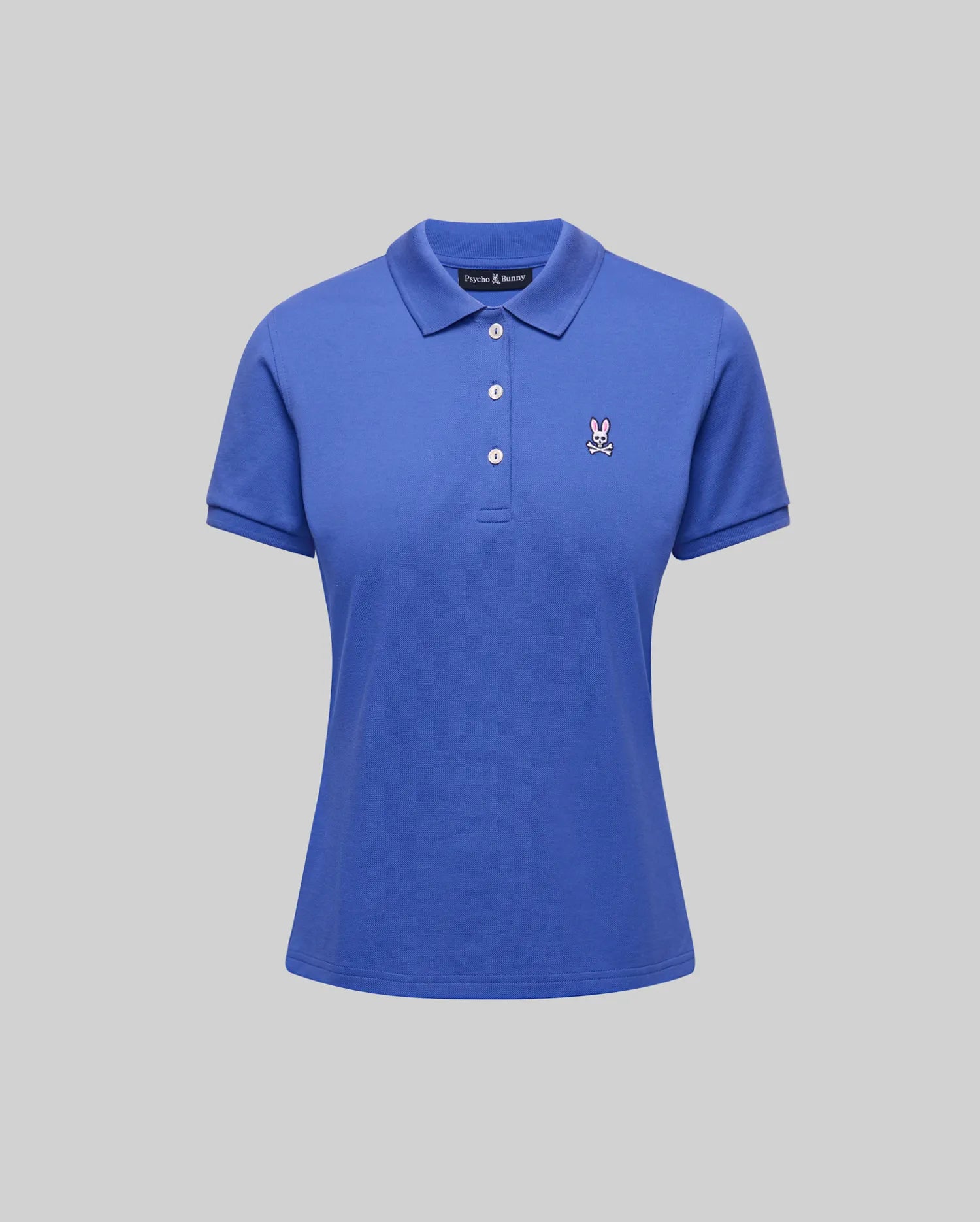 Women's Classic Pique Polo in vibrant blue, featuring a classic fit, pique fabric, a three-button placket with white buttons, and a small embroidered pink Psycho Bunny skull logo on the left chest.