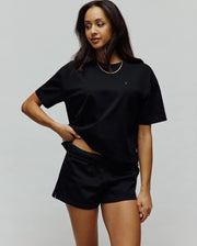 Women's Camille Oversized Fit Tee in black, featuring a relaxed silhouette and a small, tonal embroidered Psycho Bunny skull logo on the left chest.