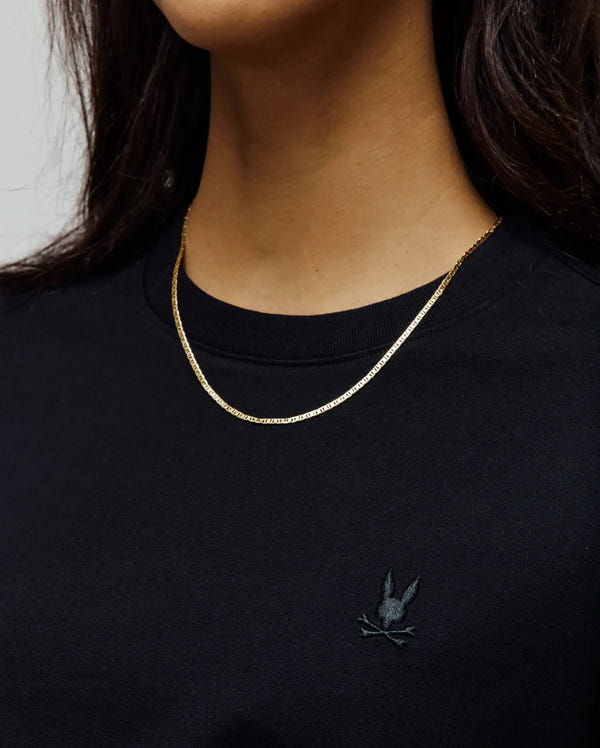 Women's Camille Oversized Fit Tee, black jersey t-shirt featuring a small, tonal dark grey embroidered Psycho Bunny skull logo on the left chest.