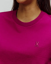 Women's Camille Oversized Fit Tee in vibrant magenta jersey knit, featuring a small, tone-on-tone embroidered Psycho Bunny skull logo on the left chest and a ribbed crew neck.