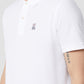 Close-up of a man wearing a white Psycho Bunny Pima cotton polo shirt with a small purple logo on the left chest area. The shirt has a crease-resistant collar and two buttons.